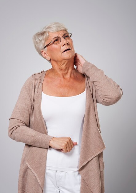 Senior woman suffering from pain of neck