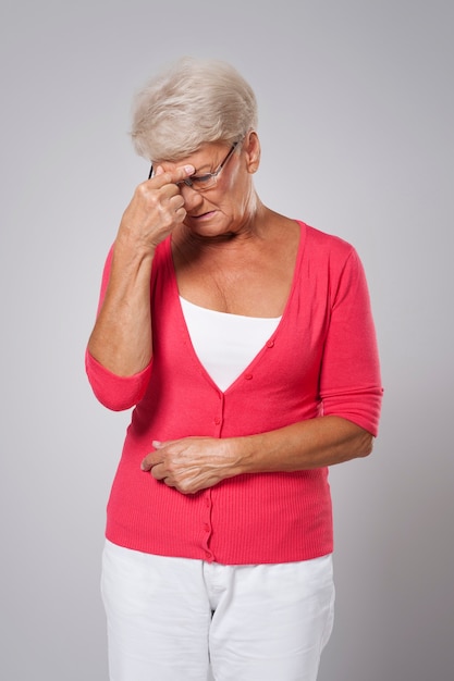 Senior woman suffering from strong headache