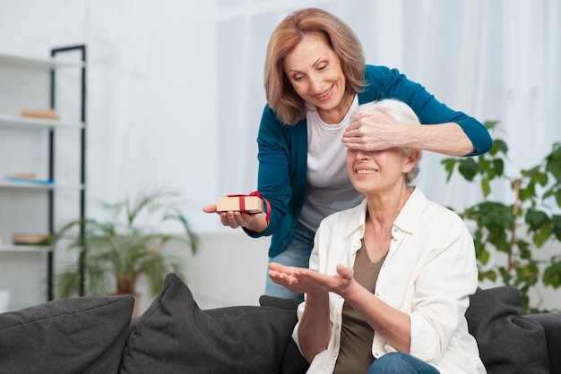 Senior woman surprising her friend