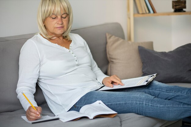 Senior woman taking notes for her next class