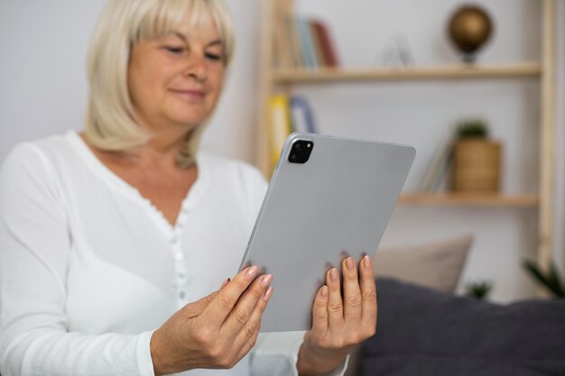 Senior woman taking an online class on her tablet