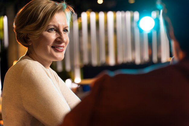 Senior woman talking and smiling while out with her friends