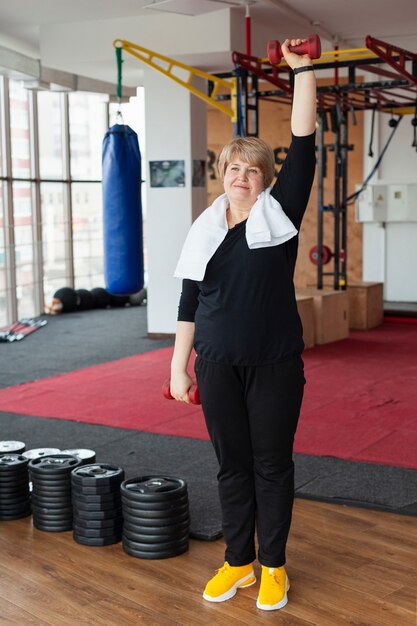 Senior woman training with weights