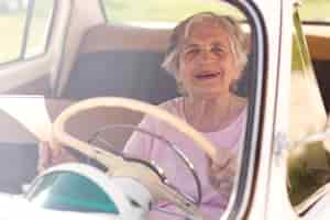 Free photo senior woman traveling alone by car