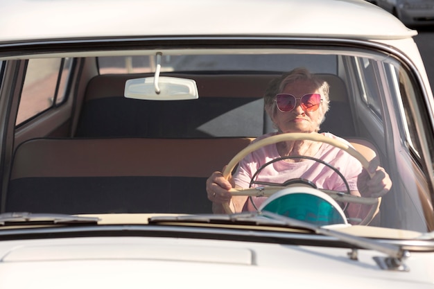 Senior woman traveling by car in daytime