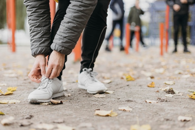 Senior woman tying her shoelaces before working out