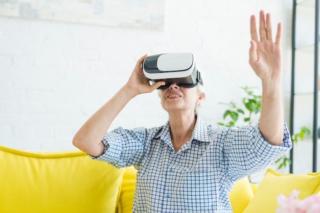 Senior woman using the virtual reality glasses