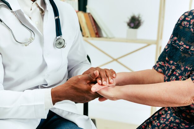 A senior woman visiting a therapist at the clinic for getting consultation and checking her health