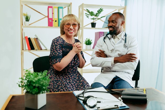 A senior woman visiting a therapist at the clinic for getting consultation and checking her health