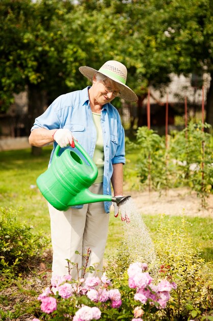 Senior woman watering a flowers