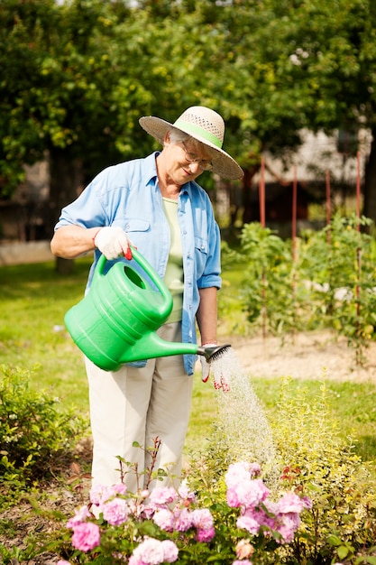 Senior woman watering a flowers