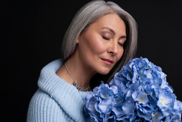 Senior woman with bouquet of flowers portrait