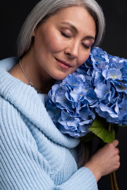 Senior woman with bouquet of flowers