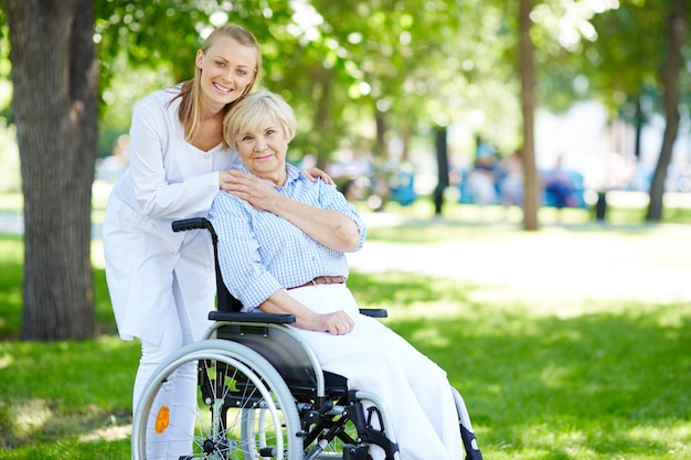 Senior woman with her caregiver outdoor