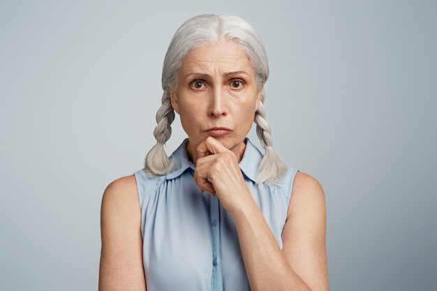 Free photo senior woman with pigtails dressed in blue blouse