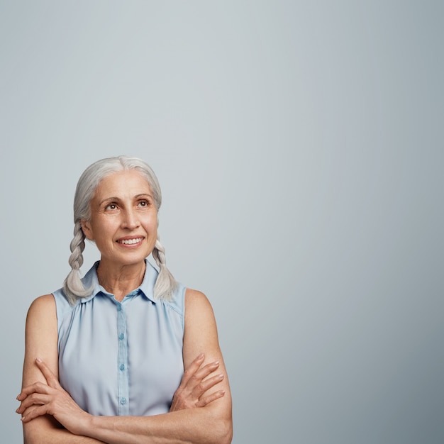 Free photo senior woman with pigtails dressed in blue blouse