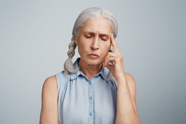 Senior woman with pigtails dressed in blue blouse