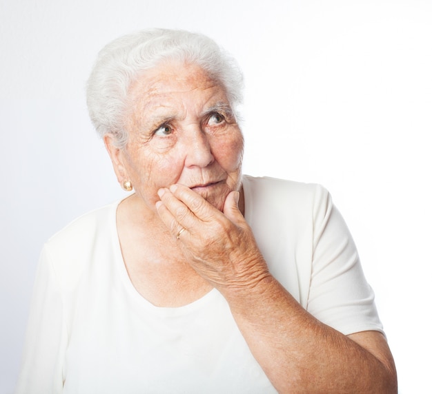 Senior woman worried with hand on face