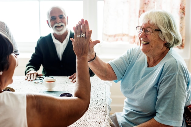 Free photo senior women giving each other high five