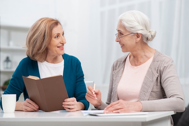 Free photo senior women looking at each other