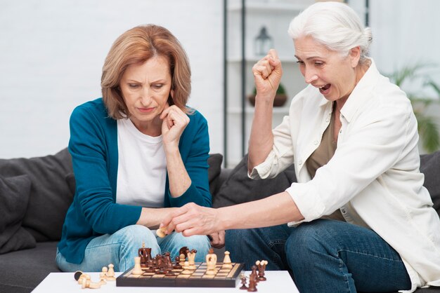 Senior women playing chess together