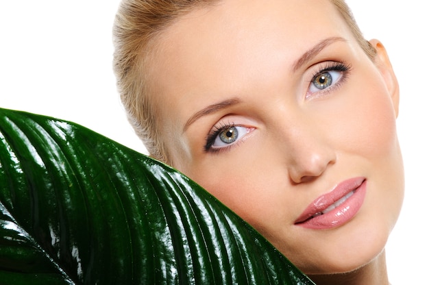 Free photo sensitive beautyful woman face with a plant