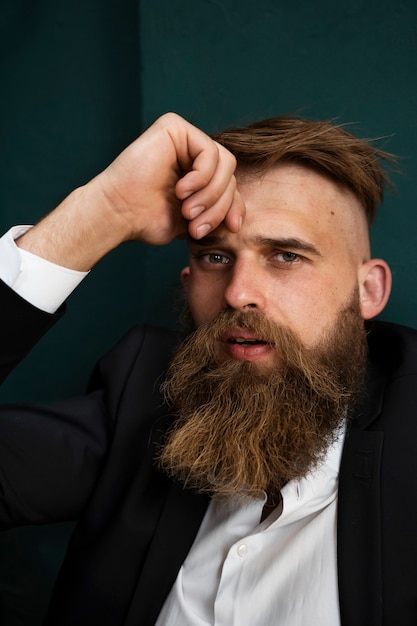 Free photo sensitive man posing in studio medium shot