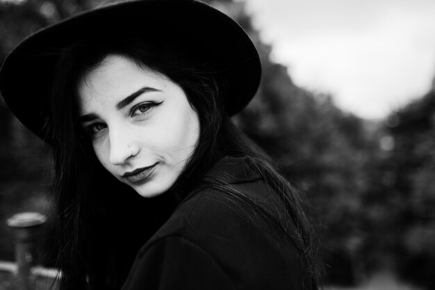 Sensual girl all in black red lips and hat Goth dramatic woman Black and white portrait