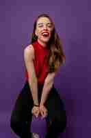 Free photo sensual lovely girl with wonderful smile wearing red top laughing on violet