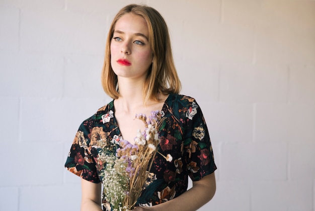 Free photo sensual pensive woman with bouquet of dry plants