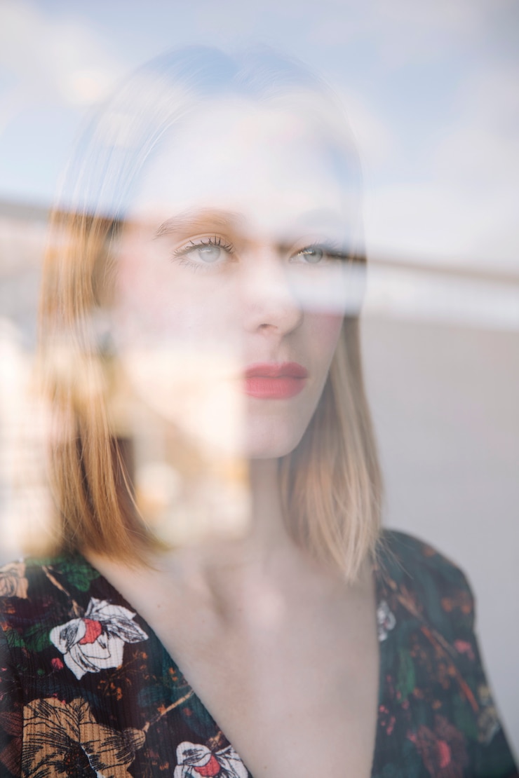 Free Photo sensual serious woman behind window