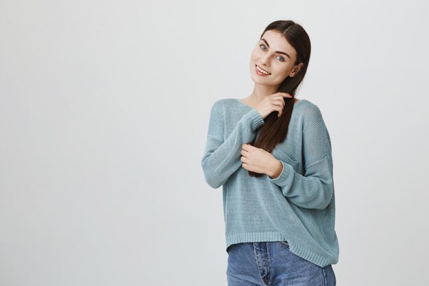 Sensual smiling, attractive woman brushing hair