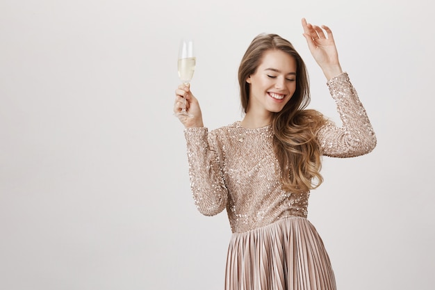 Sensual woman in evening dress partying with champagne