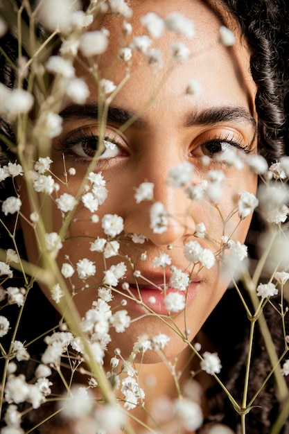 Sensual woman behind flower twigs 