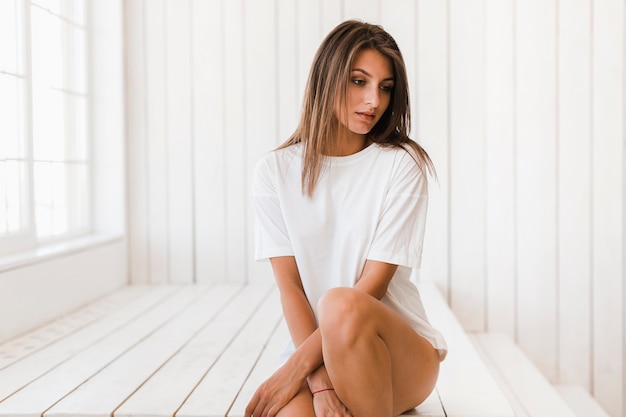 Free photo sensual woman looking away in white room