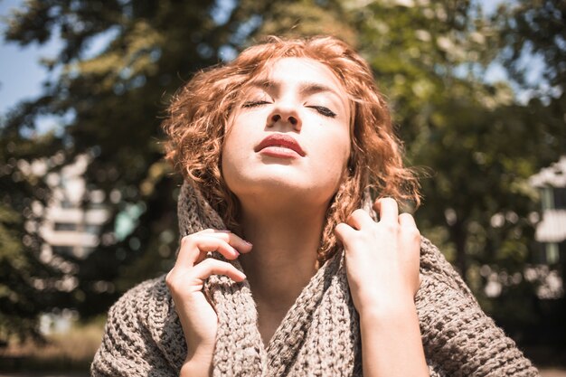 Sensual woman in scarf enjoying weather