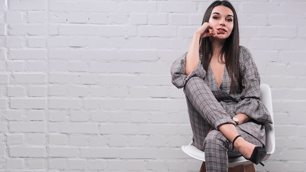 Free photo sensual woman sitting on chair