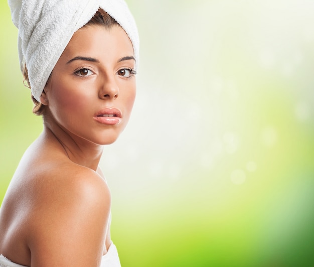 Free photo sensual woman in towel against green background.