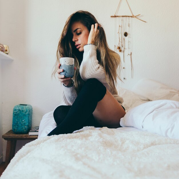 Sensual woman with hot beverage