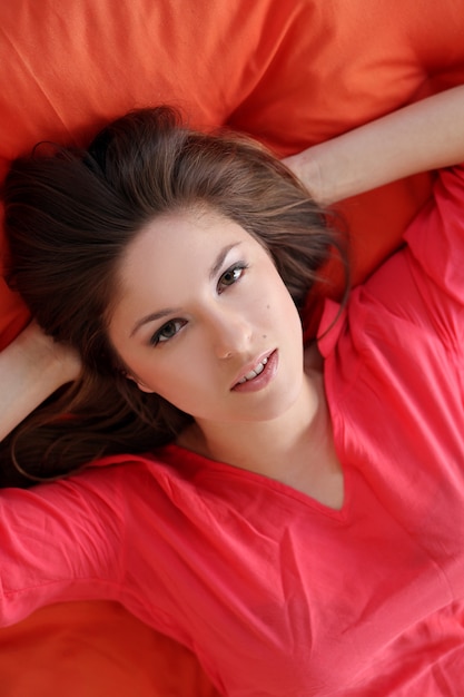 Free photo sensual young woman dreaming on a blanket