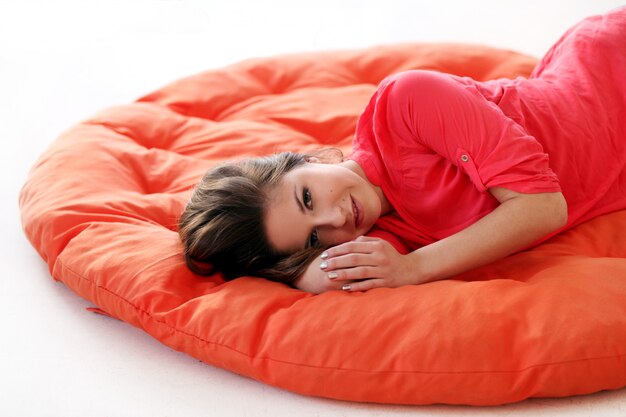 Sensual young woman dreaming on a blanket