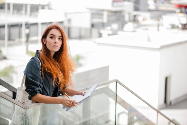 Sensual young woman with papers