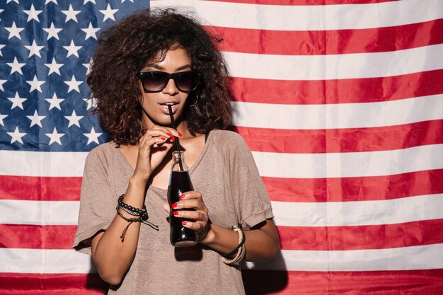 Serious african young lady wearing sunglasses