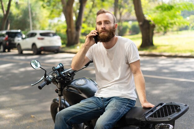 Serious biker calling roadside assistance