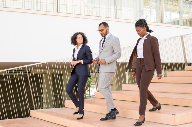 Serious business colleagues walking to their office together