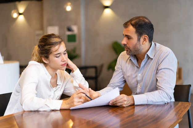 Serious business expert training new employee