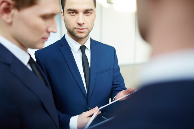 Serious businessman holding his digital tablet