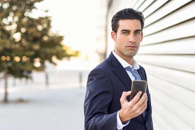  serious businessman with a mobile in hand