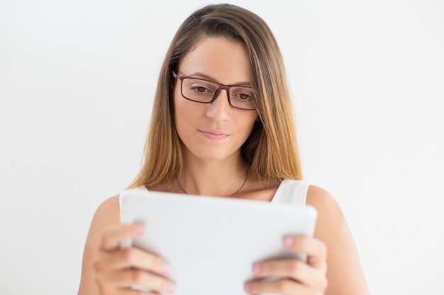 Serious businesswoman or student using touchpad