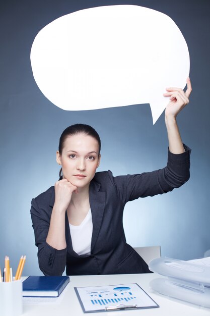 Serious businesswoman with a speech bubble